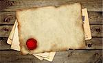 Old parchment with wax sea on wooden boards