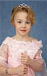 Portrait of a girl - a teenager in a beautiful dress on a blue background