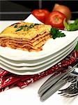 Freshly cooked lasagne plated up on a kitchen bench