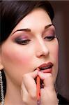 closeup brunette young lady get ready for the event by makeup artist