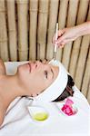 spa beauty facial treatment oil brush and bougainvillea flowers
