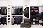 Luxury men's clothes and accessories in modern shop interior