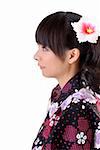 Beautiful japanese woman with traditional clothes and flower on head with copyspace on white.