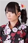 Young attractive girl of Asian on japanese traditional clothes with cool eyes and sight.
