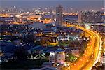 a freeway heading to the middle of Bangkok in dusk