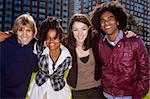 A group of people in front of an apartment building taken into the sun with solar flare