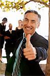 An asian looking business man with thumbs up - critical focus on eyes