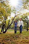 A happy couple walking in the park - looking at the camera