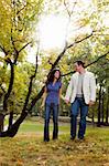 A happy couple walking in the park - looking at each other