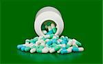 Open bottle medicine pill spilling out isolated on green background