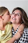 Beautiful mother and daughter on a white background