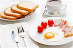 English breakfast with egg, bacon and tomatoes