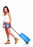 Beautiful young woman carrying a blue suitcase, isolated on white background