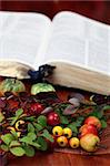 Autumn arrangement and the Bible in background. Shallow dof