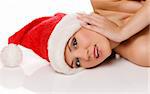 close up portrait of a blond cute girl wearing a christmas hat and laying down on a white floor