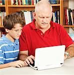 Confused father tries to help his son do homework on the netbook computer.
