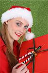 Christmas girl holding a red gift box with decorations