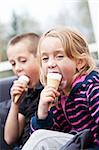 Happy siblings eating ice-cream
