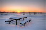 Beautiful winter sunset with a table and benches