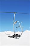 Ski lift chairs on bright winter day