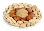 Pistachios, walnuts, hazelnuts on a white background, isolated