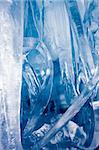 Bottom-up view of blue icicles. Freezing atmosphere