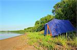 tent outdoors - camping on river beach