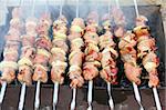 shashlik - cooking barbecue on grill close-up