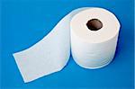 Modern Toilet Paper Concept Image on a Blue Background.