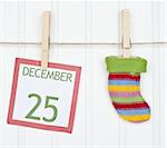 Holiday Stocking or Sock on a Clothesline with a Christmas Calendar Page.