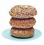 Everything Bagels Stacked on a Blue Plate. Isolated on White with a Clipping Path.