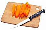 Sliced Orange Bell Pepper with Knife on Chopping Block Isolated on White with a Clipping Path.