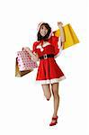 Happy shopping Christmas woman with bags isolated over white.