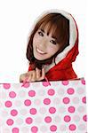 Attractive shopping girl in Christmas clothes showing smiling face.