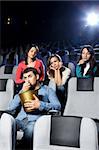 Enamoured girls admire the attractive man at cinema