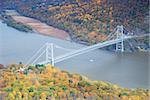 Bear Mountain bridge aerial view in Autumn with colorful trees in forest over Hudson River in New York State.