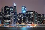 New York City Manhattan skyline night scene over Hudson River.