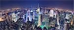 New York City Manhattan Times Square panorama aerial view at night with office building skyscrapers skyline illuminated by Hudson River.