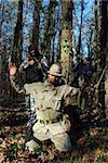 US soldiercriminal taking armed US soldier under arrest with forest behind