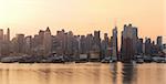 Manhattan urban skyline panorama in New York City at sunrise over Hudson River