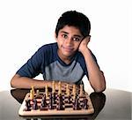 An handsome Indian kid playing chess game