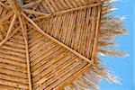 straw wooden sunshade texture over blue sky in resort
