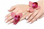 Beautiful hand with perfect nail pink manicure and purple orchid flower. isolated on white background