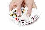 Beautiful hands with perfect  manicure holding a deck of playing cards. isolated on white background