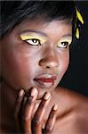 Beautiful young African female model with feathers