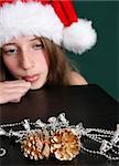 Brunette Teenager wearing a christmas hat. FOCUS ON DECORATIONS