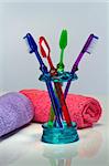 Toothbrush and bath towels against a white background in a studio environment