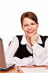 Young happy business woman sits on desk in office. Isolated on white background.