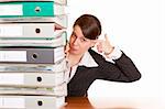 Frustrated business woman behind folder stack gets headshot. Isolated on white background.