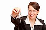 Smiling woman gives over house key. Isolated on white background.